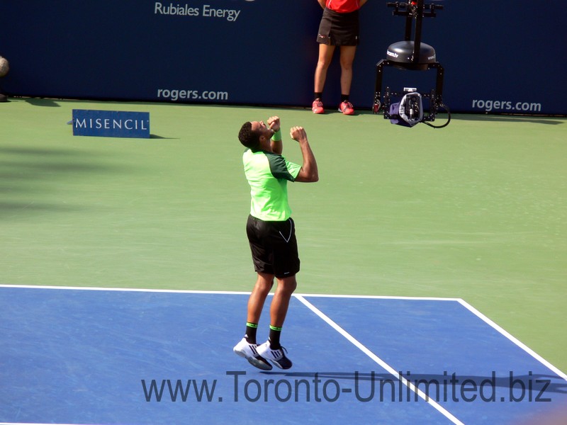 Jubilant Jo-Wilfried Tsonga jumps in the air with excitement of winning Rogers Cup