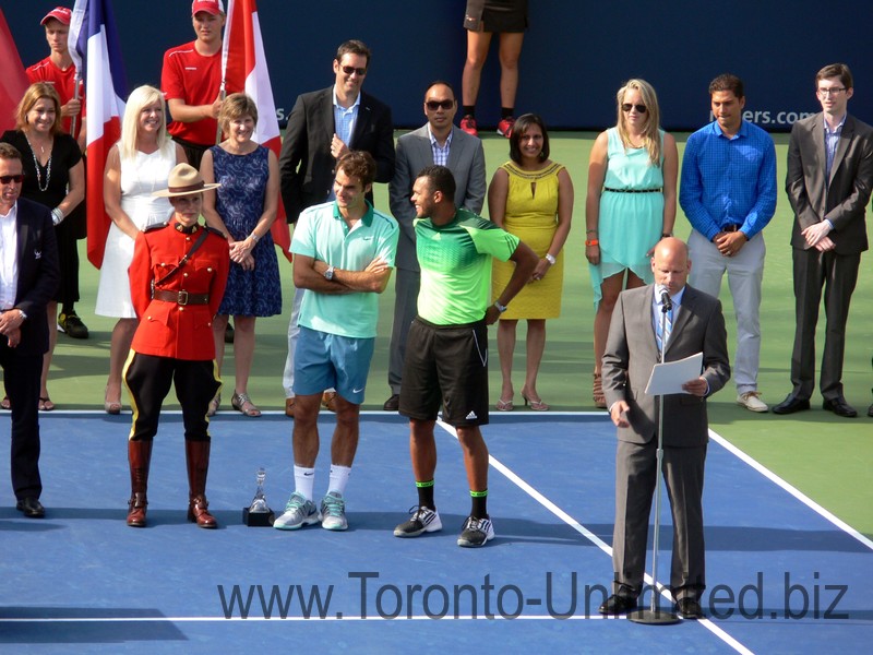 Rogers Cup Stadium Court Master of Ceremonies Ken Crosina giving speech, while Roger Federer and Jo-Wilfried Tsonga look on August 10, 2014 Rogers Cup Toronto 