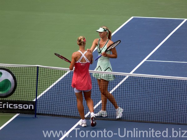 Dementieva and Sharapova shaking hands at the net.