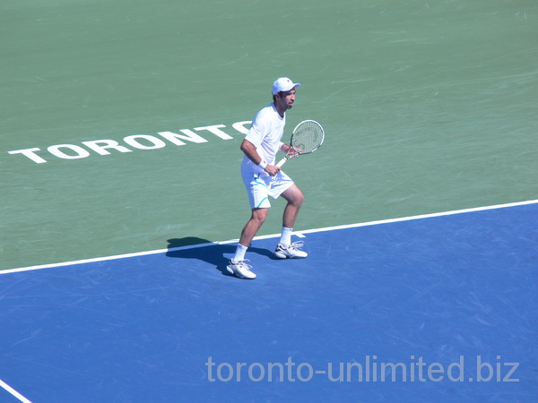 Mikhail Kukushkin of Kazachstan on Centre Court with Frank Dancevic August 7, 2012 Rogers Cup.