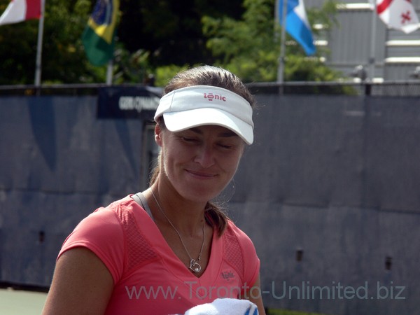 Martina Hingis with forced smile on the practice court August 8, 2013 Rogers Cup Toronto