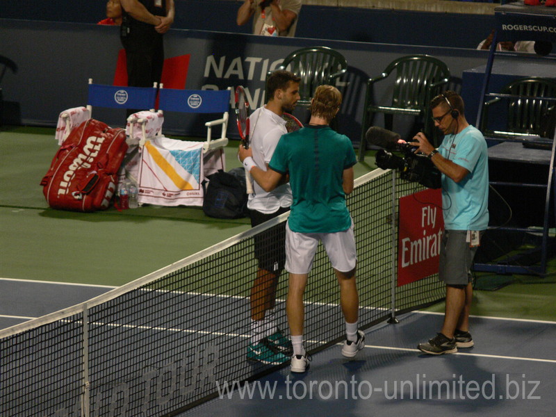 Dimitrov and Shapovalov with handshake after the win by Dimitrov on Centre Court 27 July 2016 Rogers Cup Toronto