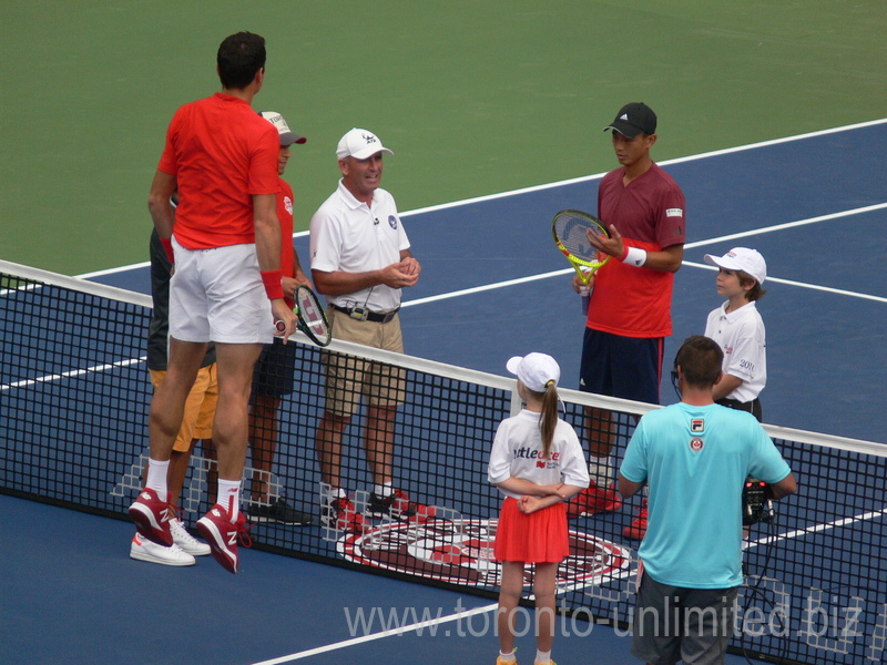 Jumping Milos Raonic during coin-toss with Yen-Hsun LU (TPE) on Centre Court 27 July 2016 Rogers Cup Toronto