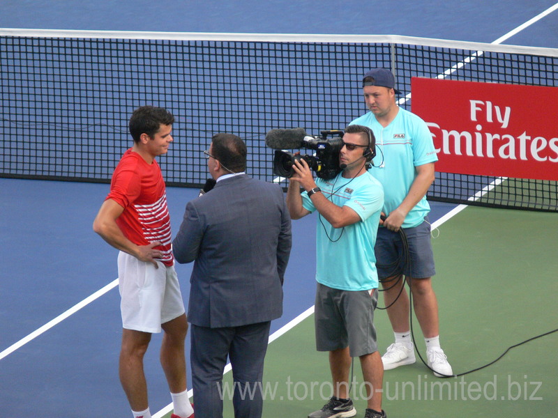 Milos Raonic (CDN) with Arash Madini during postgame interview 27 July 2016 Rogers Cup in Toronto
