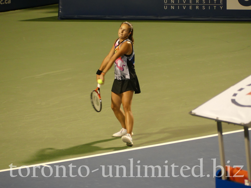 Daria Kasatkina serving on Stadium Court during evening match, to Bianca Andreescu CDN,