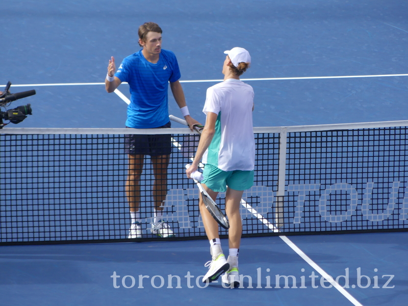 The match is over, and Alex De Minaur and Jannik Sinner are about to shake hands at the net