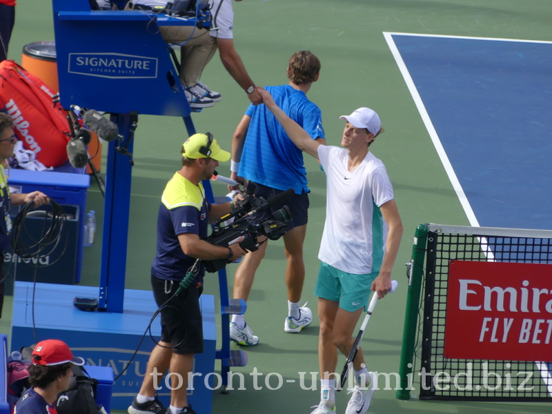 Jannik Sinner is shaking hands with the umpire