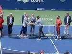 Daniel Nestor hands a Trophy bearing his name to Michael Denham for the presentation to the Winners.