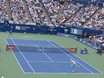 Jannik Sinner serving to Alex De Minaur on Centre Court