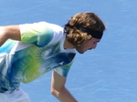 Stefanos Tsitsipas dribbling the ball before the serve