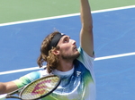 Stefanos Tsitsipas is tossing the ball to serve on Centre Court National Bank Open 2023