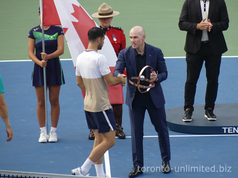 Matthew Evans of the National Bank is presenting the Doubles Championship Trophy to  Lloyd Glasspool on August 7, 2025, NBO 2025 Toronto 