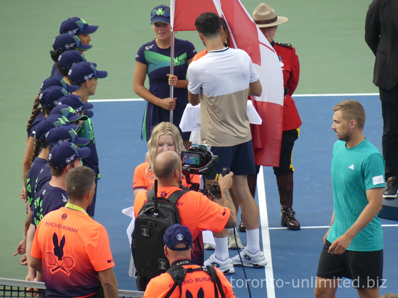 Lloyd Glasspool is presenting the ball crew with commemorative medals.