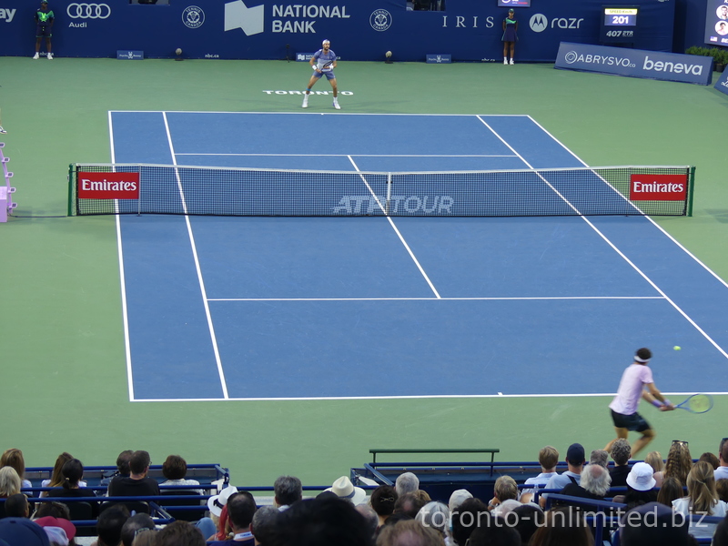 Ben Shelton is returning the serve from Karen Khachanov on Centre Court in the NBO 2025 Championship Final, August 7, 2025