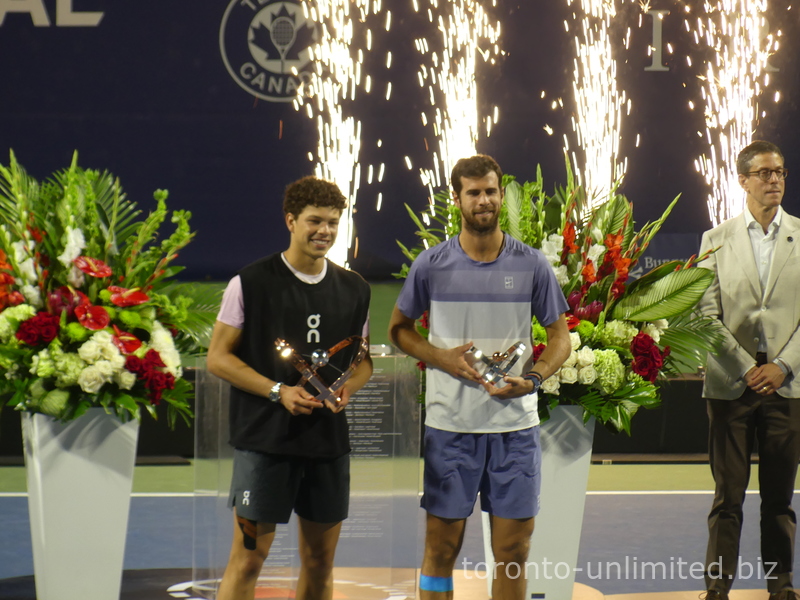Ben Shelton and Karen Khachanov are holding their Championship Trophies. August 7, 2025