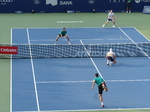 Julian Cash is serving on Centre Court in the second set tiebreaker on August 7, 2025, in the Championship Doubles Final.