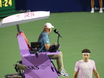Chair Umpire Fergus Murphy is looking away, and Ben Shelton is at the Net.