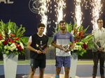 Ben Shelton and Karen Khachanov are holding their Championship Trophies. August 7, 2025