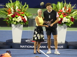 Ben Shelton and Lucie Blanchet are holding the Championship Trophy during the NBO 2025 Closing Ceremony. 