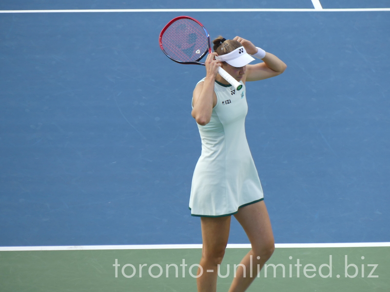 Elena Rybakina on the Court fixing her visor