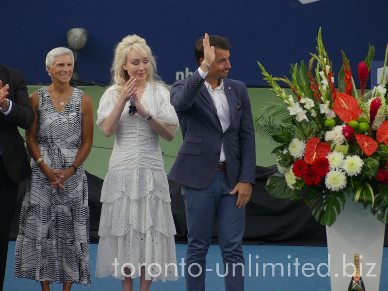 A guest member of the official party with raised hand