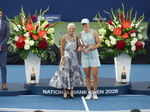 Iga Swiatek holding her Trophy and posing with Lucie Blanchet