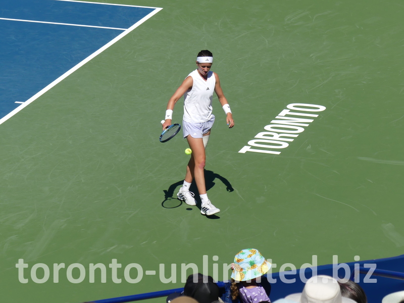 Nikola BARTUNKOVA walks with a dribbling tennis ball. 