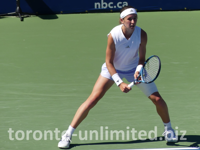 Nikola BARTUNKOVA behind baseline expecting to return serve.