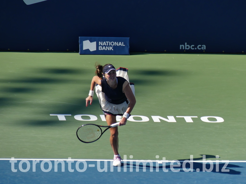 Kayla Day is in serving posture on Centre Court. 