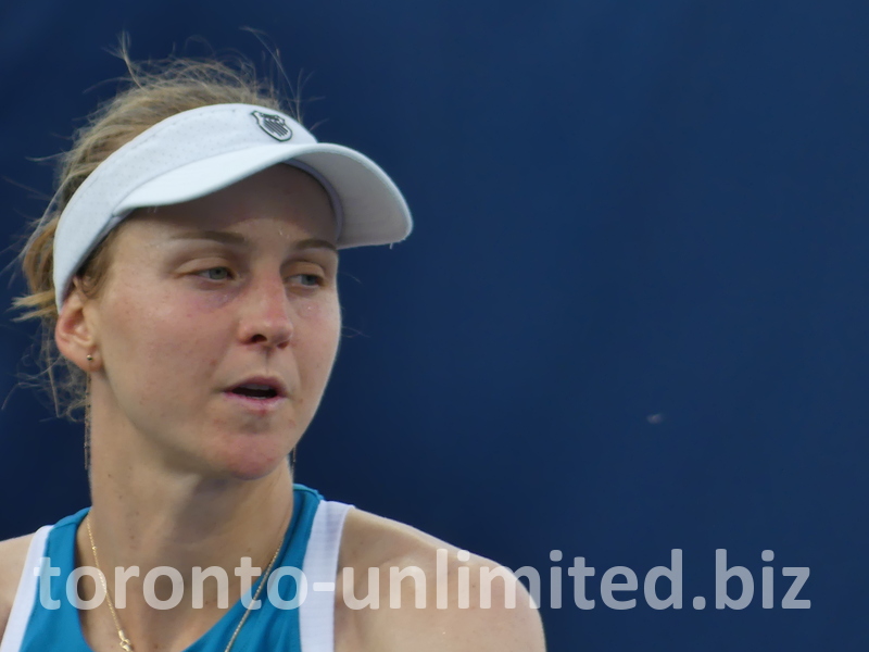 Liudmila Samsonova is preparing to serve, and her concentration is on her face.