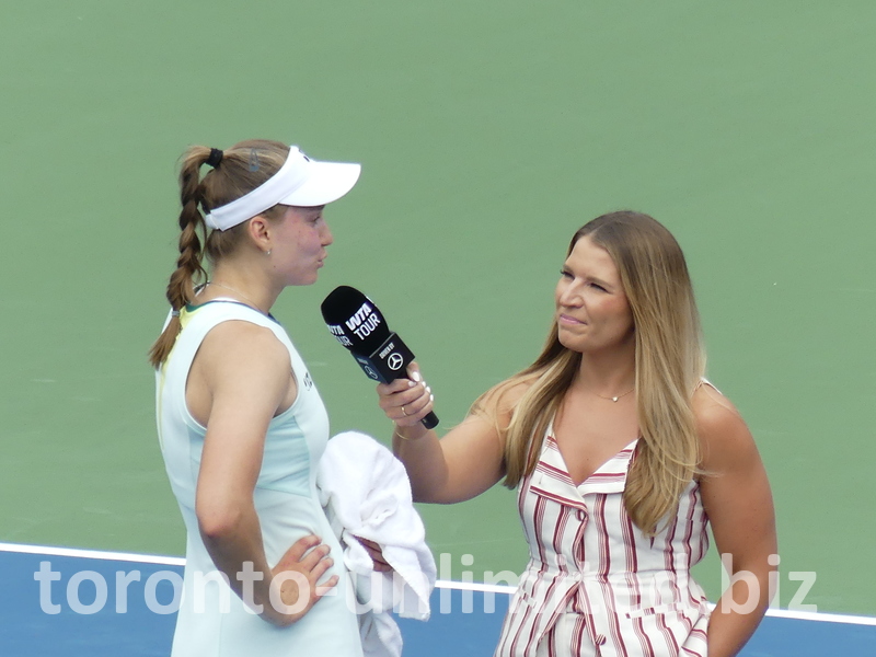 A closeup of Elena Rybakina with a WTA Tour Reporter.