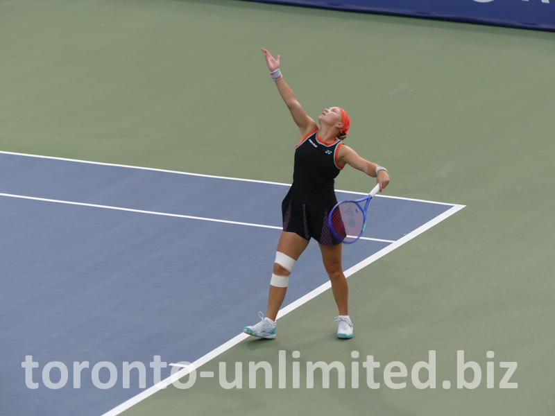 What a high ball toss; Diana Shnaider follows with her eyes for her serve.