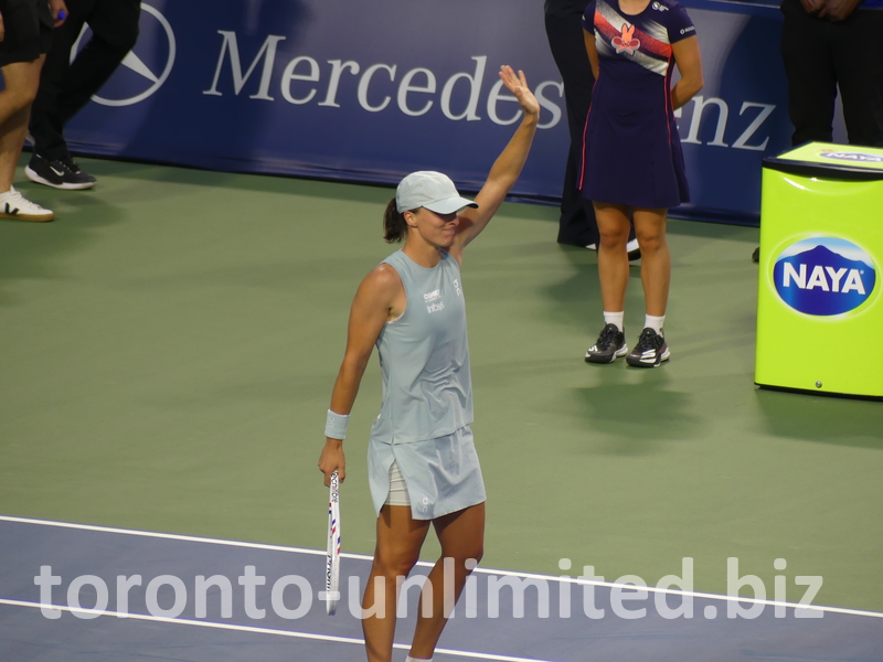 Victorious Iga Swiatek celebrates on the Court.