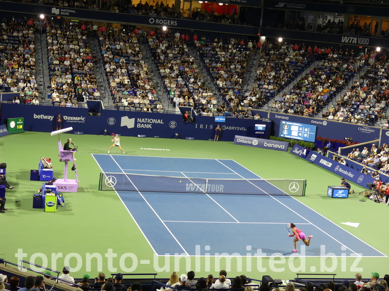 Night play on the Centre Court with Naomi Osaka serving to Elena Rybakina.