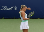 Sara Bejlek concentrates, with her tongue visible.