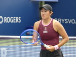 Close-up photo of Xiyu WANG in a tennis match on a tennis court.