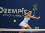 Here, the tennis ball is close to Sara Bejlek, ready to strike it.