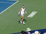 Nikola BARTUNKOVA walks with a dribbling tennis ball.