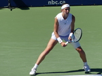 Nikola BARTUNKOVA behind baseline expecting to return serve.
