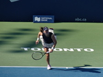 Kayla Day is in serving posture on Centre Court.