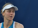 Liudmila Samsonova is preparing to serve, and her concentration is on her face.