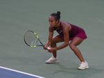 Crouching, Leylah Fernandes expects to return the serve.