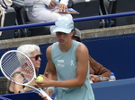 Close-up of Iga Swiatek with the hat.