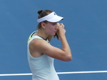 Another close-up photo of Elena Rybakina fixing her hairdo on the Court.