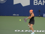 Diana Shnaider during her warm-up with Iga Swiatek.