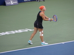 Diana Shnaider is preparing her serve to Iga Swiatek.