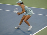Iga Swiatek reacts dynamically to the play.