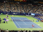 Night play on the Centre Court with Naomi Osaka serving to Elena Rybakina.