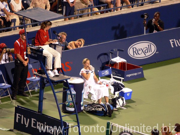 Kim Clijster during changeover in a match against Elena Baltacha.