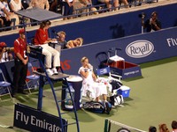 Kim Clijster during changeover in a match against Elena Baltacha.